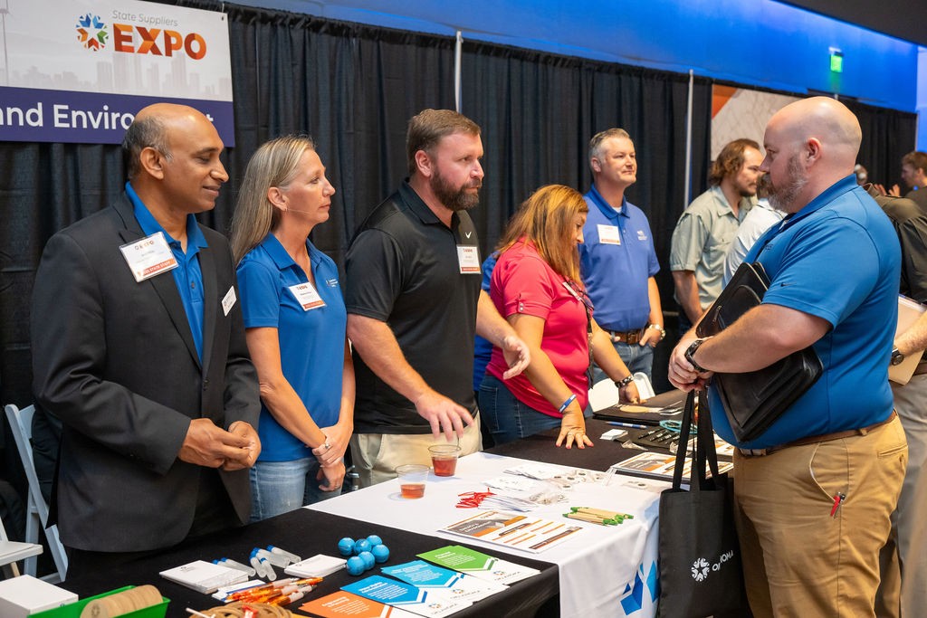Energy and Environment booth staff talk to supplier attendee