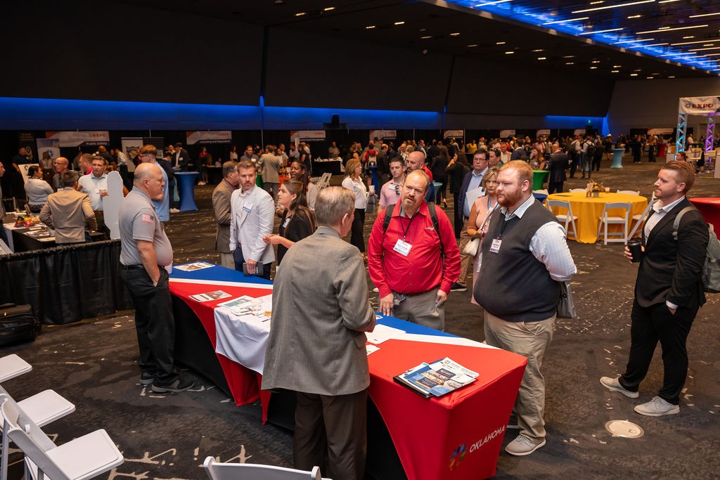 Wide angle of attendees interacting with ballroom booths
