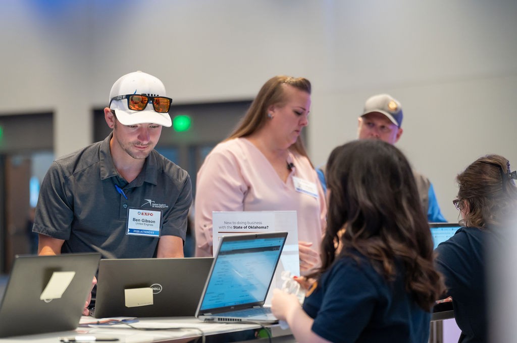 Supplier uses laptop at Supplier Registration booth