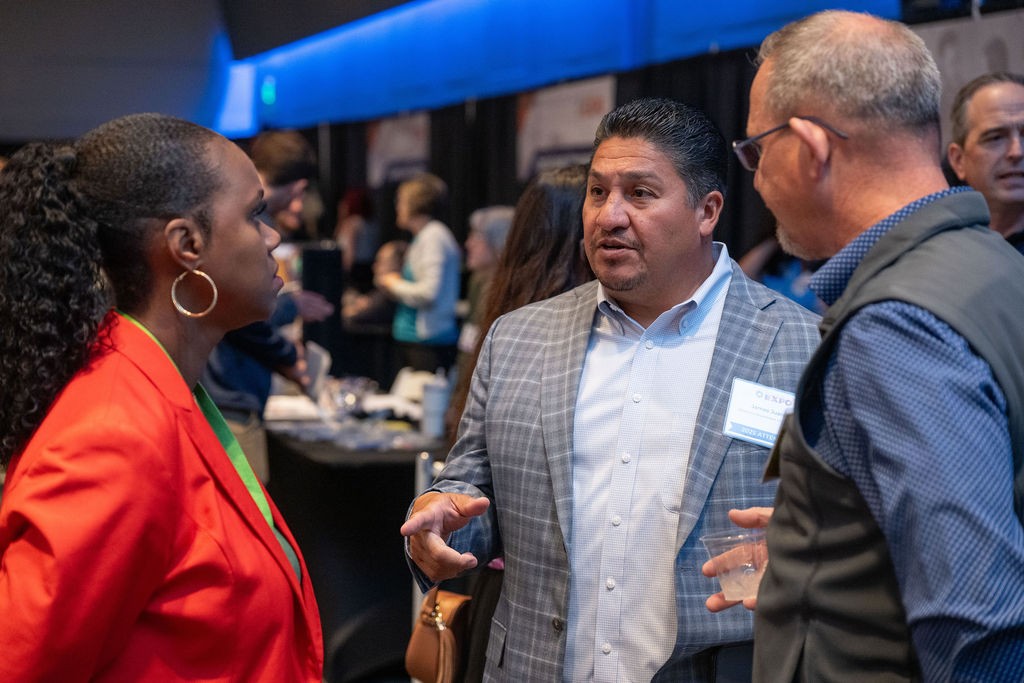 Two attendees speak to state staff