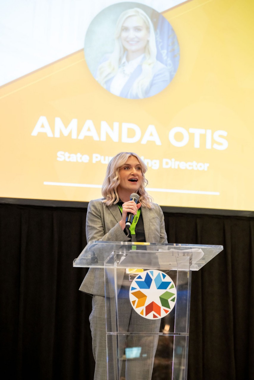 State Purchasing Director Amanda Otis delivers welcome remarks at podium