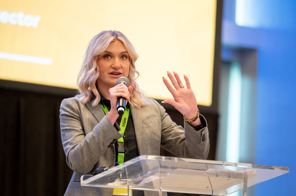 State Purchasing Director Amanda Otis delivers welcome remarks and gestures