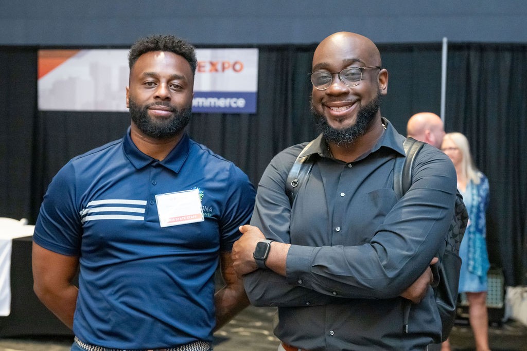 State staff smiling at Commerce booth