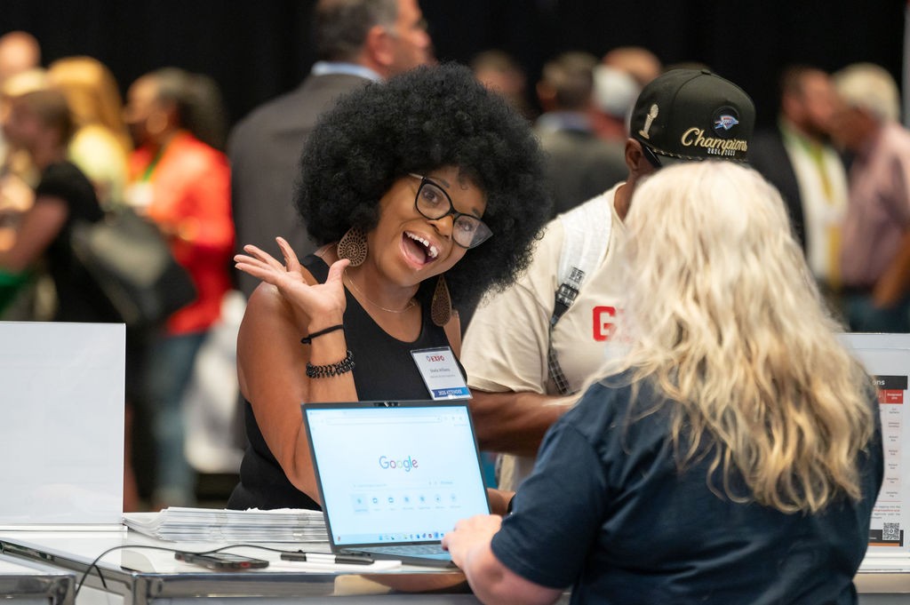 Supplier attendee smiling at Supplier Registration booth
