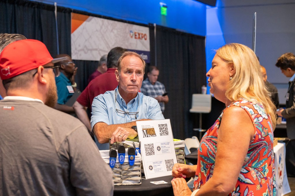 Attendees conversing with state employee at Energy and Environment booth