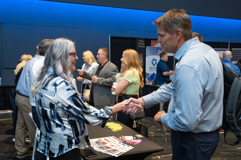 State employee shaking hands with attendee