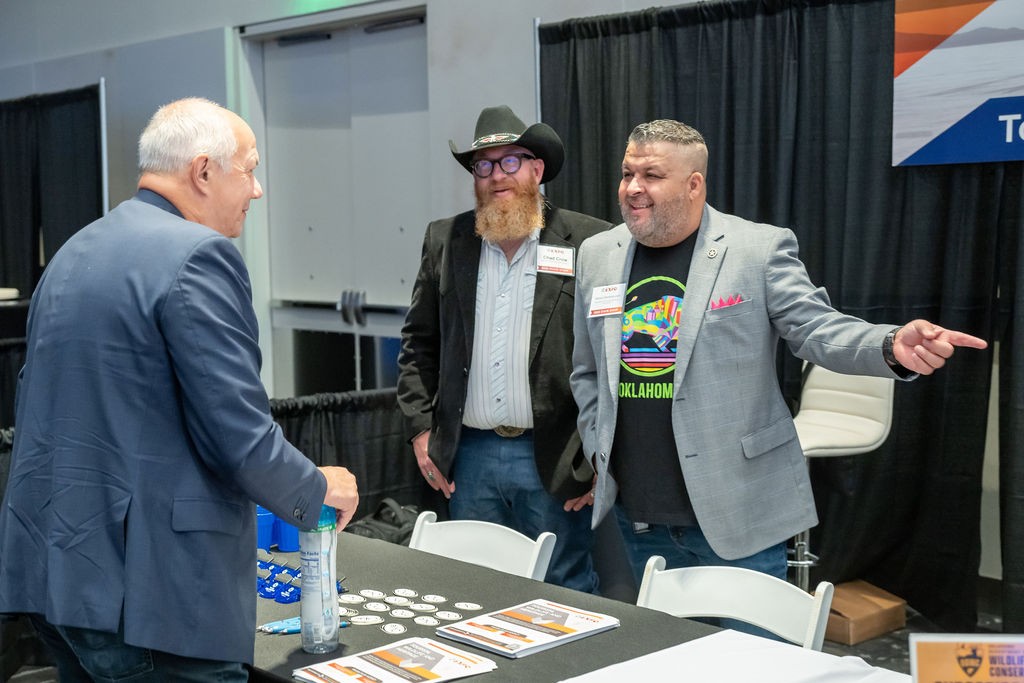 Two OTRD employees engage with suppliers at the Tourism, Wildlife and Heritage booth