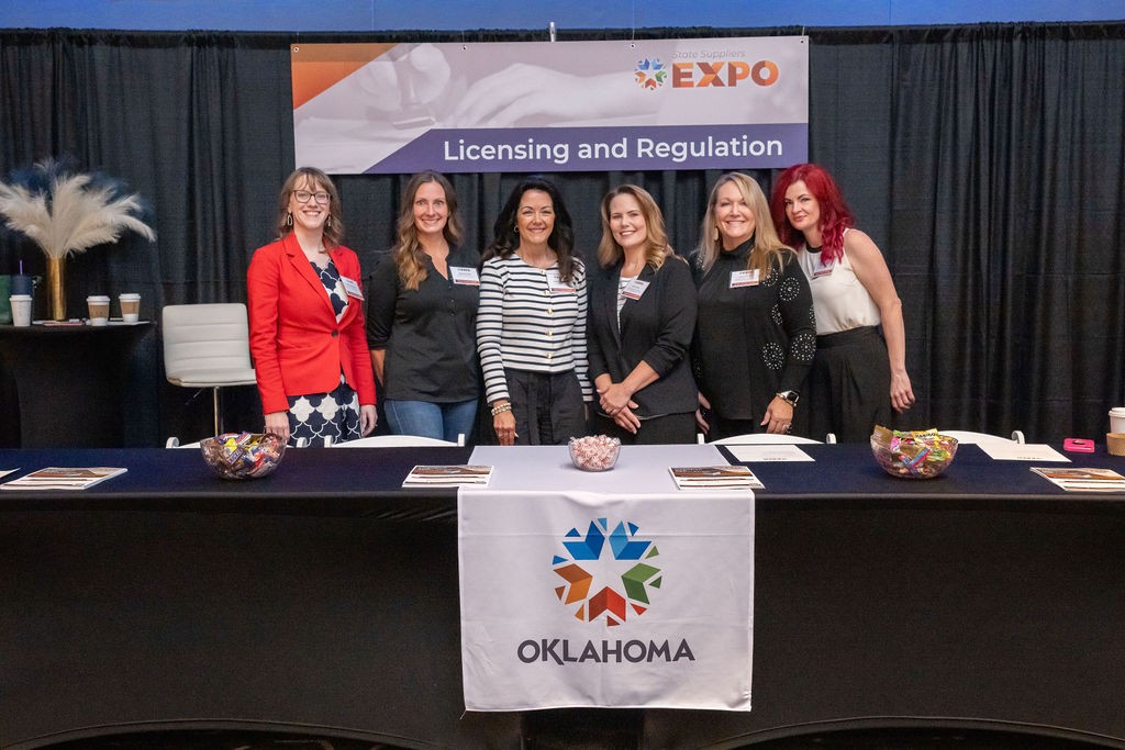 State staff smiling at Licensing and Regulation booth