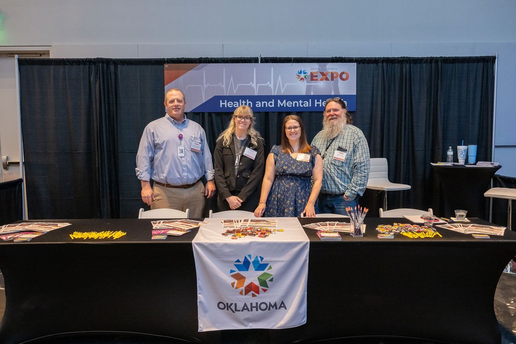 State staff smiling at Health and Mental Health booth