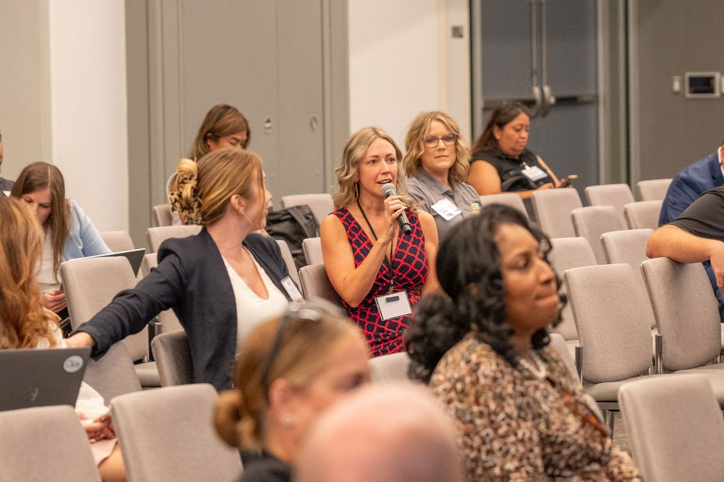 Supplier attendee holds microphone to ask question during a Central Purchasing breakout session