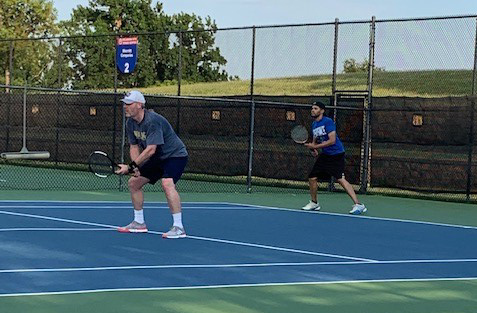 two men team in a tennis match