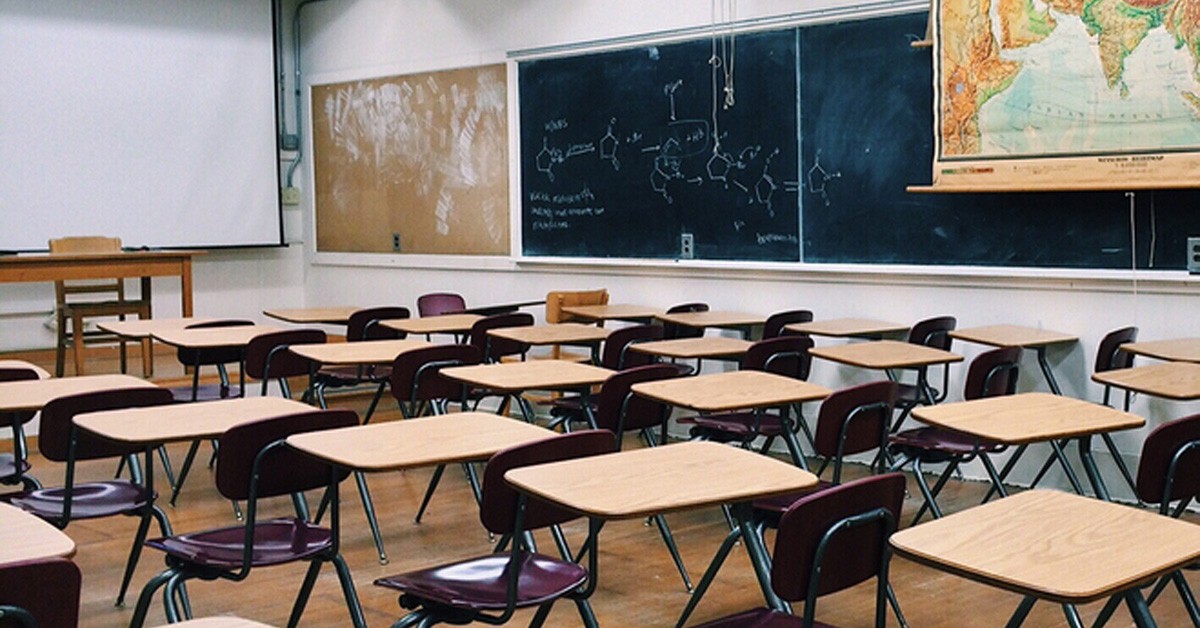 Empty classroom full of desks